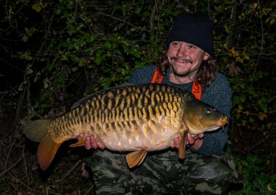 Angler holding a common carp at Scarlett’s Lake